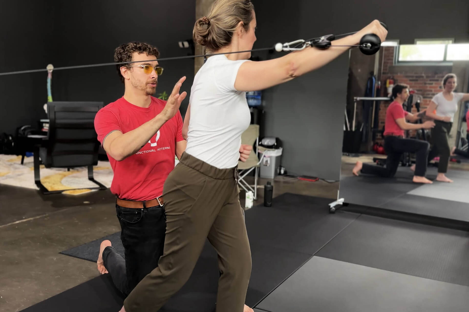 Functional Patterns Chattanooga trainer Chris Carlson with a client on a pulley machine